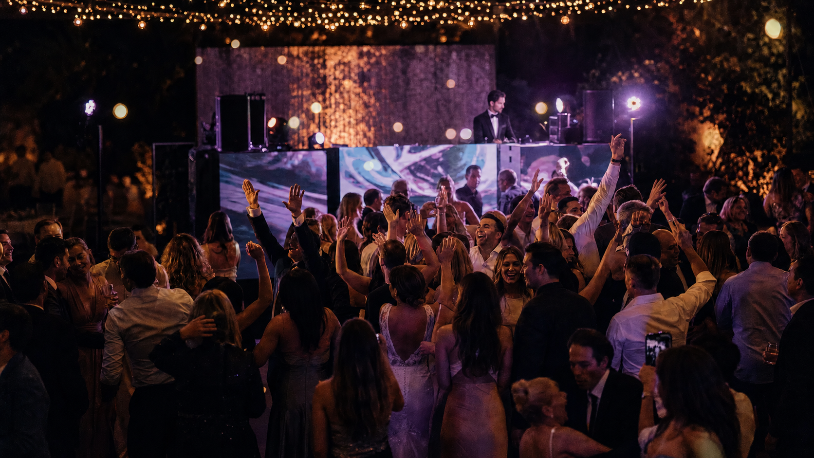 Curtis Butcher DJing at a wedding with packed dancefloor